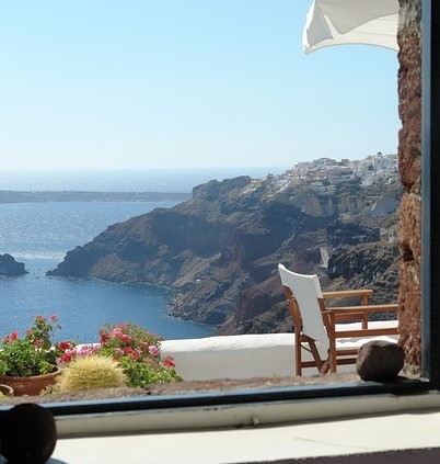 Ocean view from balcony with white chair